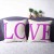 LO and VE printed in purple LOVE couple cushions